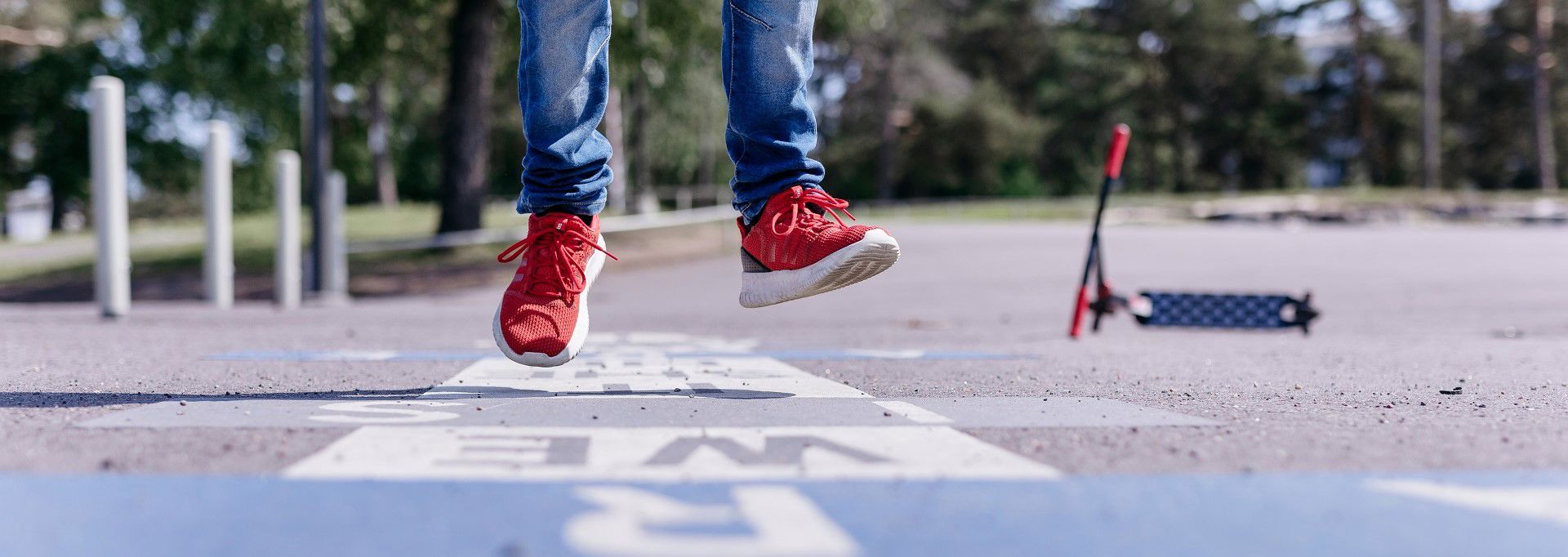 Legs jumping out of the picture on a school yard.