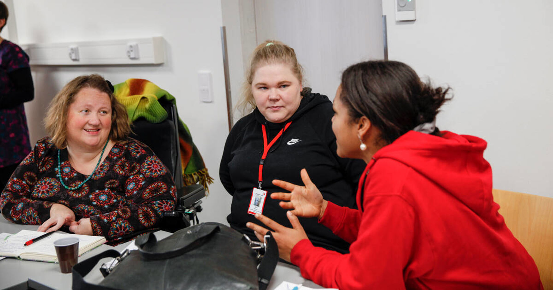 Three people having a conversation.