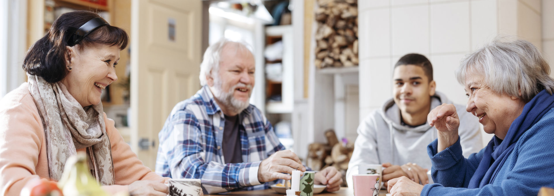People laughing together around a table.