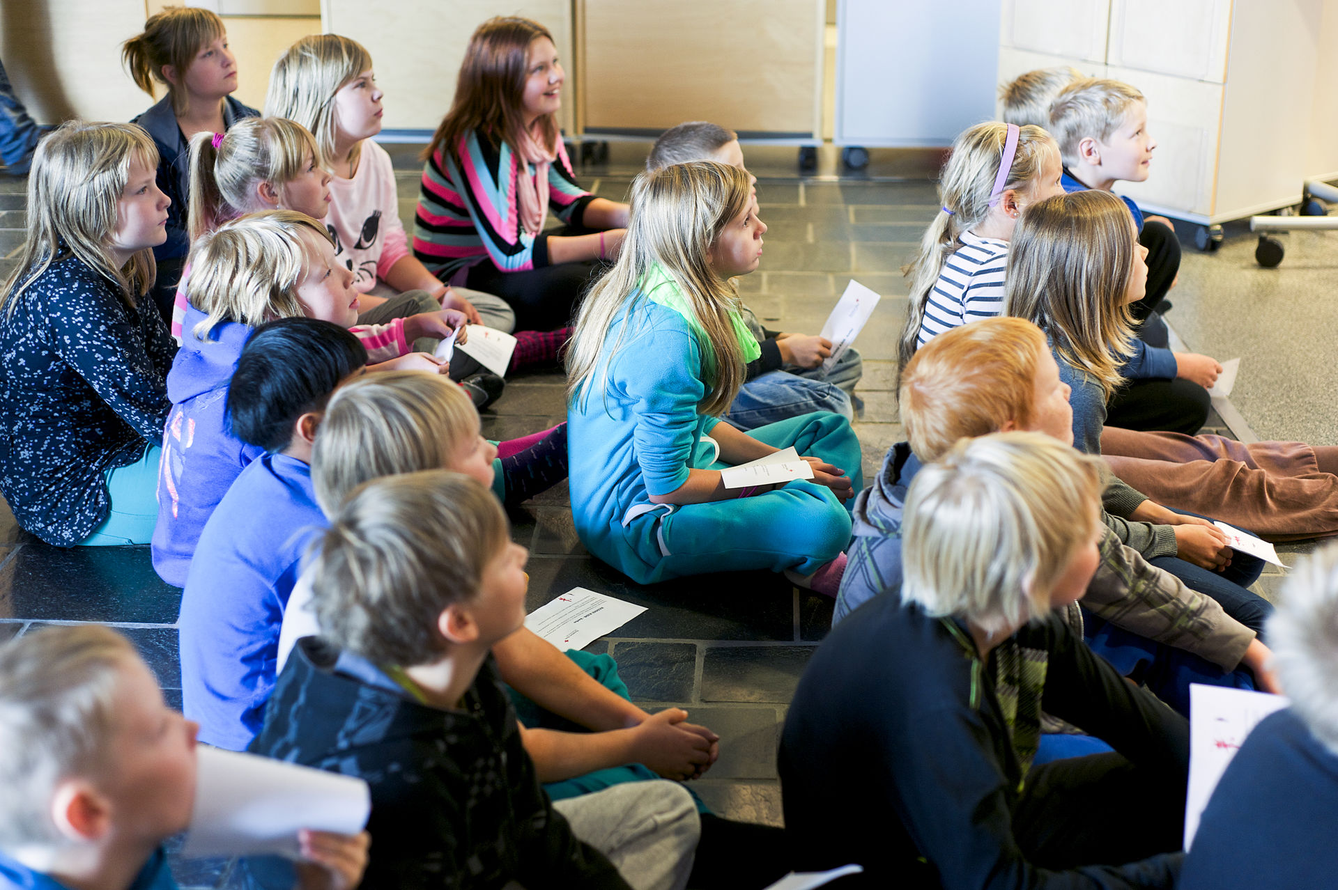 Children sitting on the floor.