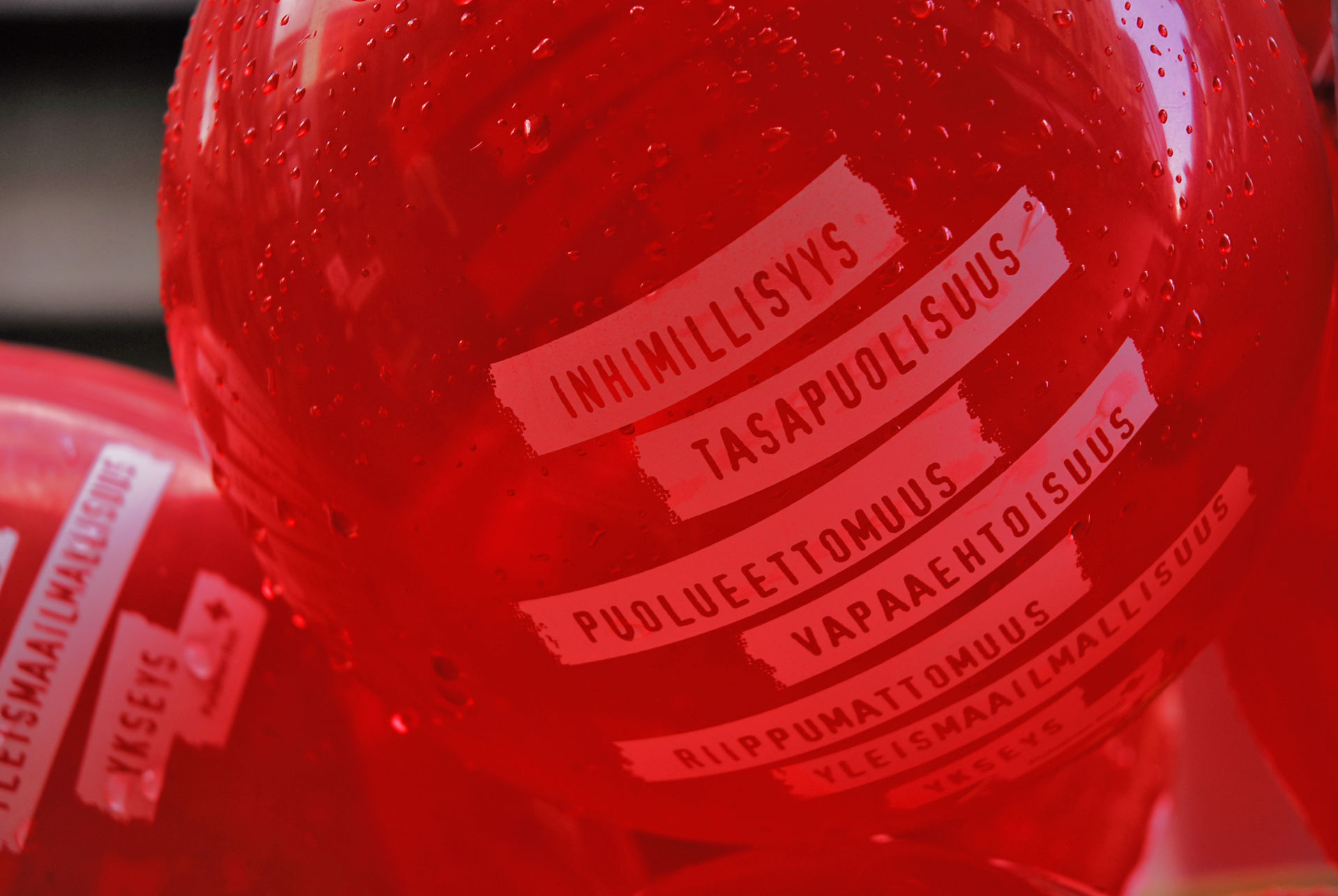 In the red balloon, it says the seven principles of the Red Cross: humanity, impartiality, neutrality, voluntary service, independence, universality and unity.