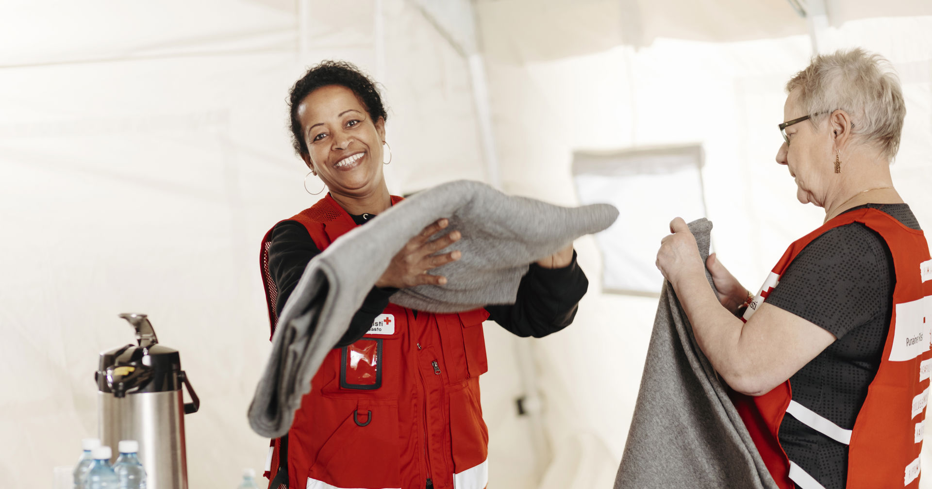 Volunteers are folding blankets.