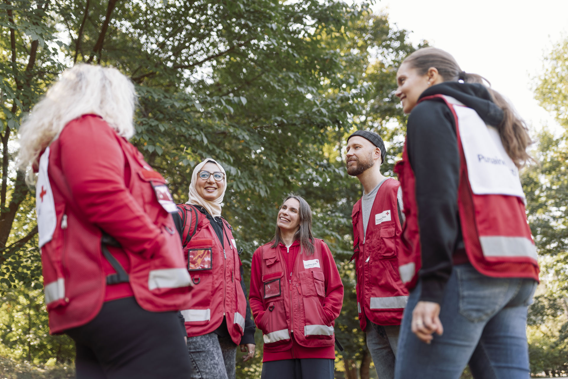 Volunteers gathered in a circle outdoors.