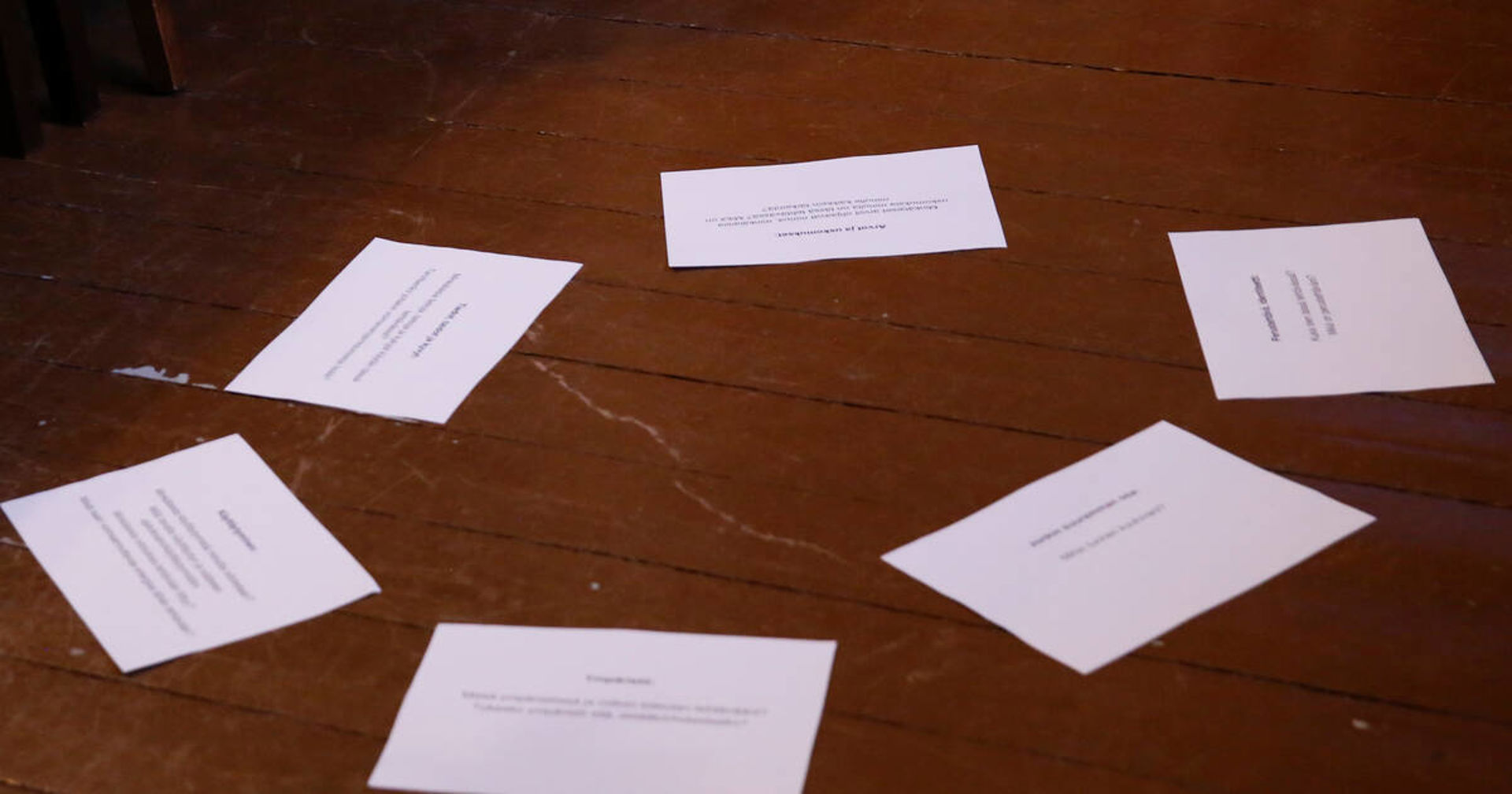 Papers are arranged in a circle on the floor.