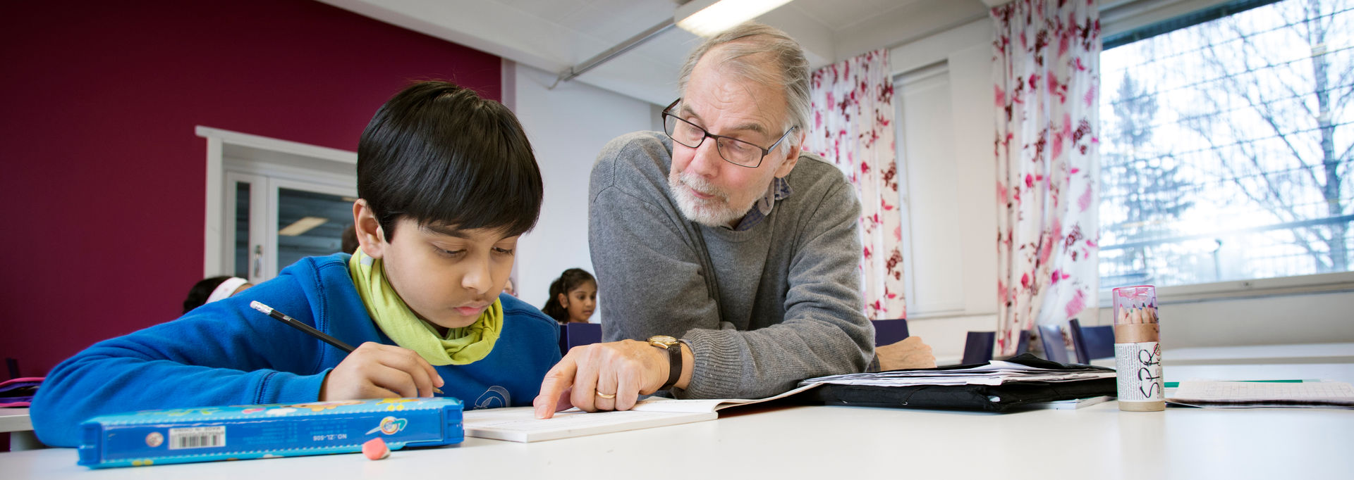 A person helping a child with their homework.