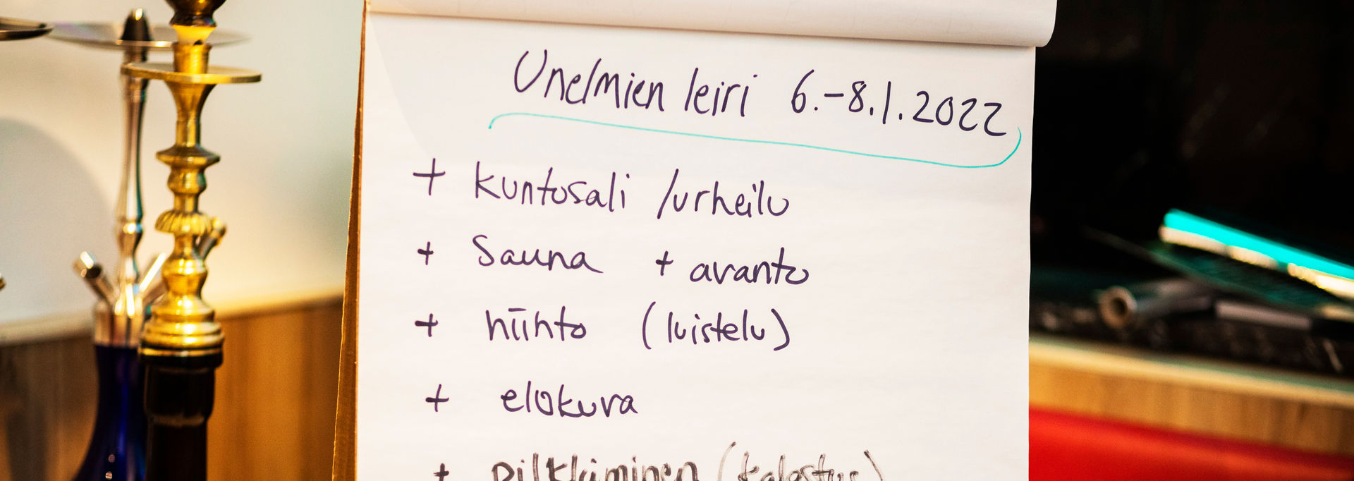 A flip chart paper with writing about a dream camp.