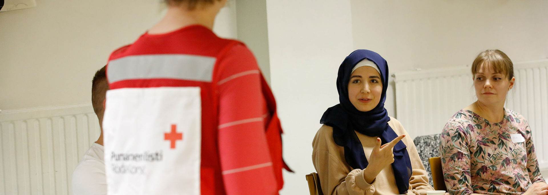 A Red Cross trainer talking with a person.