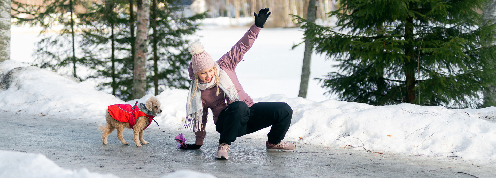 A person slips on ice in a wintry landscape.