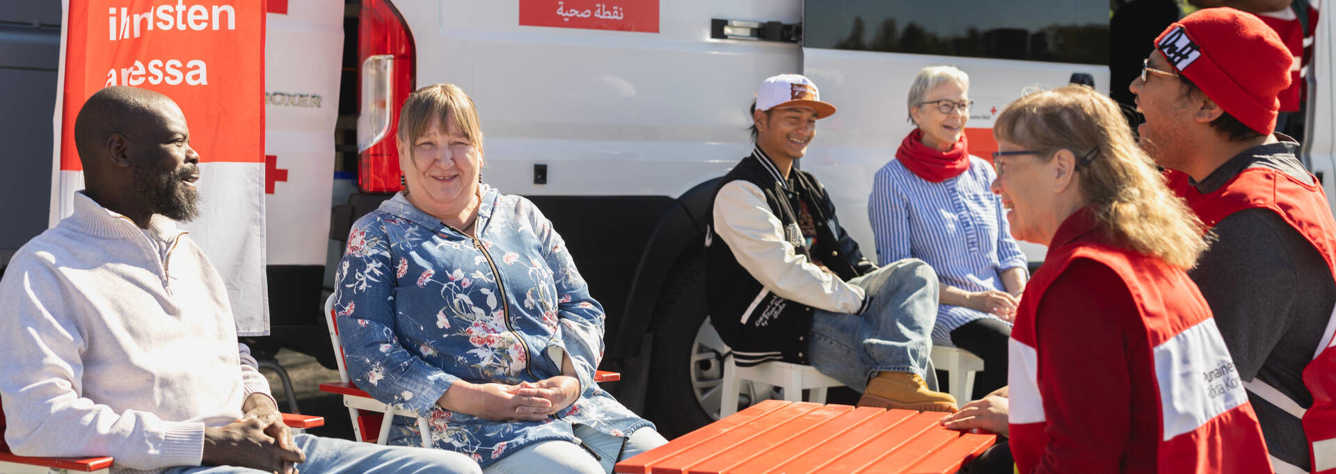 The Health Point activity group is talking with visitors in front of the mobile Health Point.