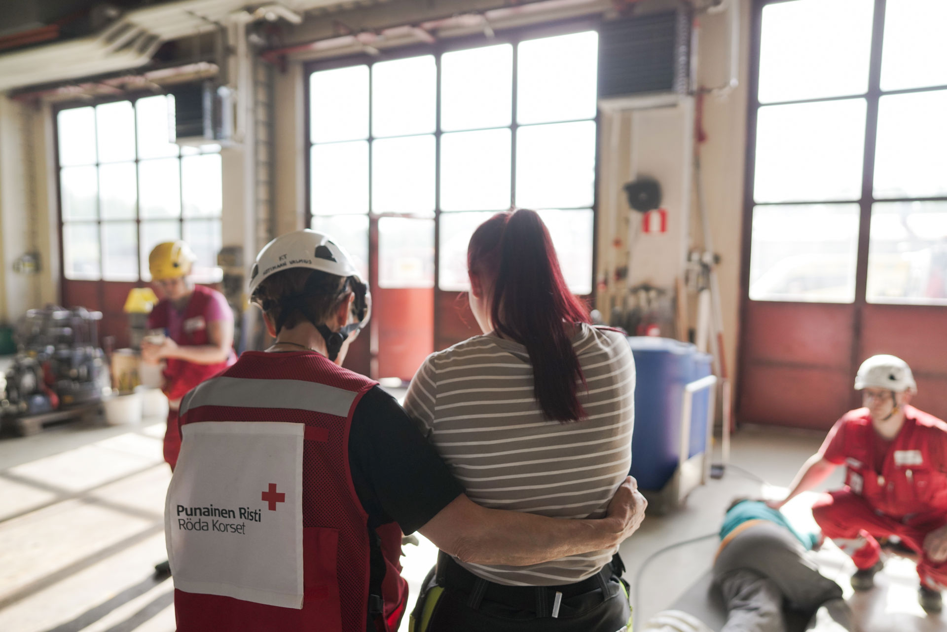 A Red Cross volunteer comforting a person.