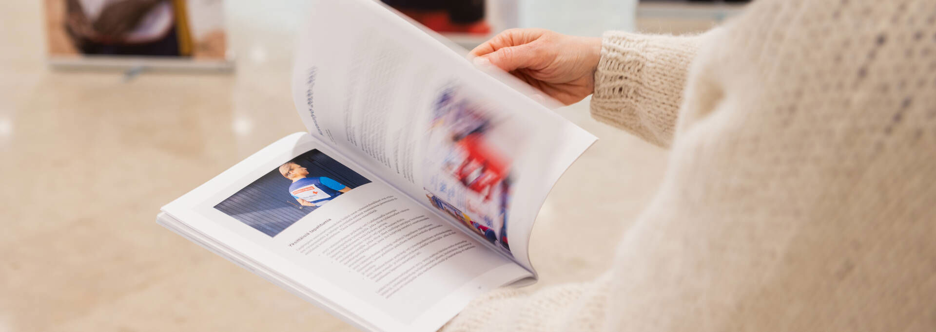 Hands browsing a leaflet.