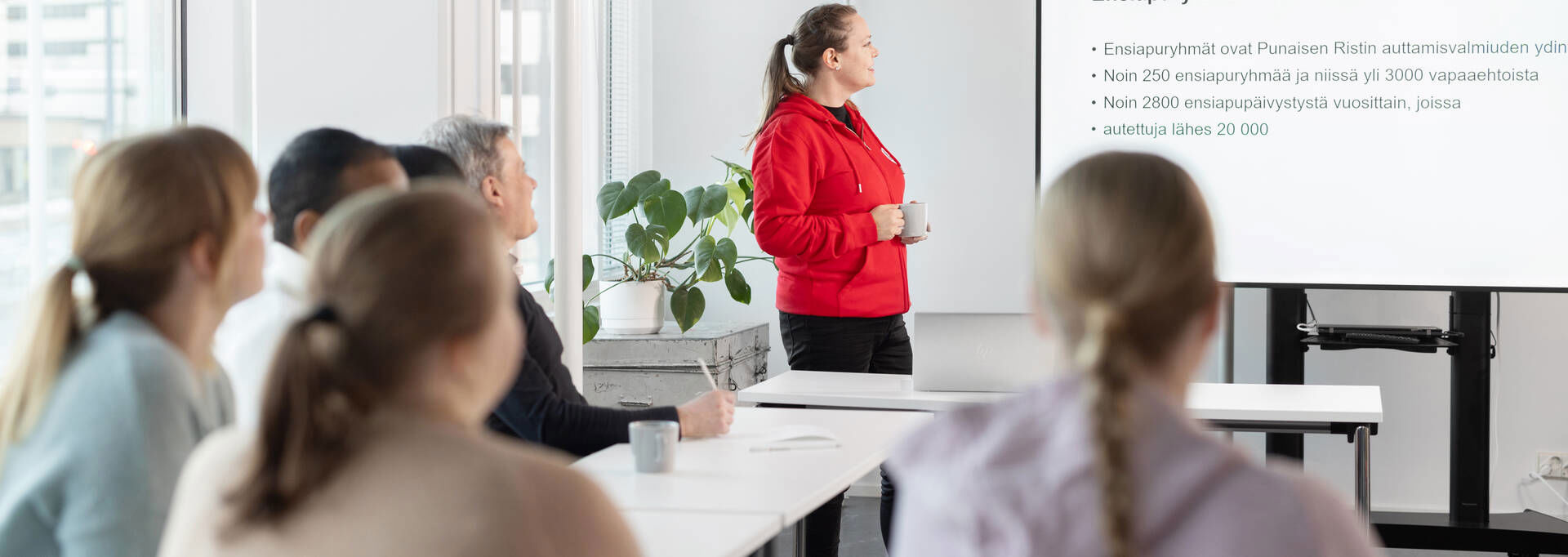 Volunteers follow a presentation led by the trainer.